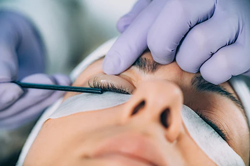 Technician applying product during an eyelash lift procedure.